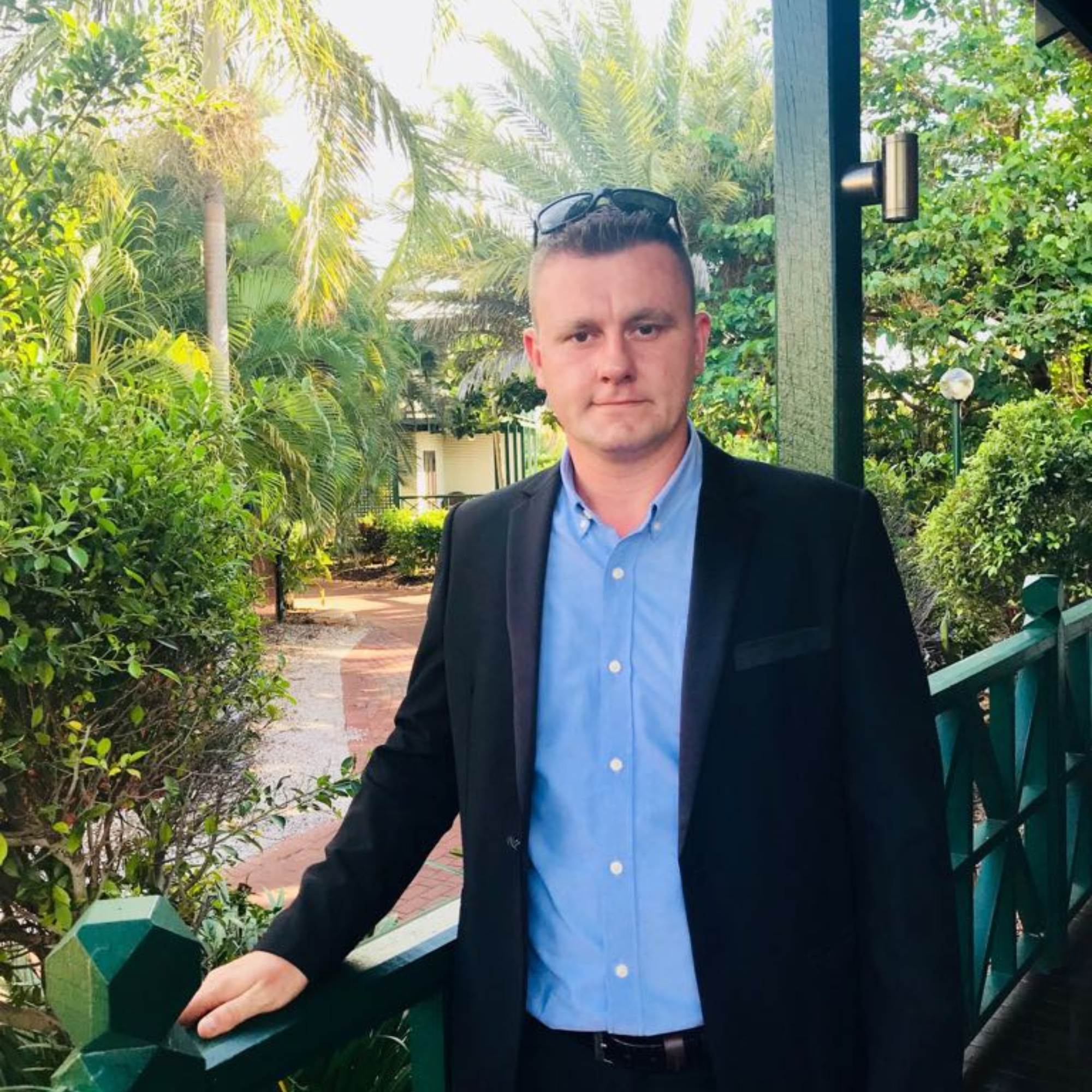 Photo of Adis Smajtic, designer and digital creator at One Stop Centre, standing outdoors by a green railing