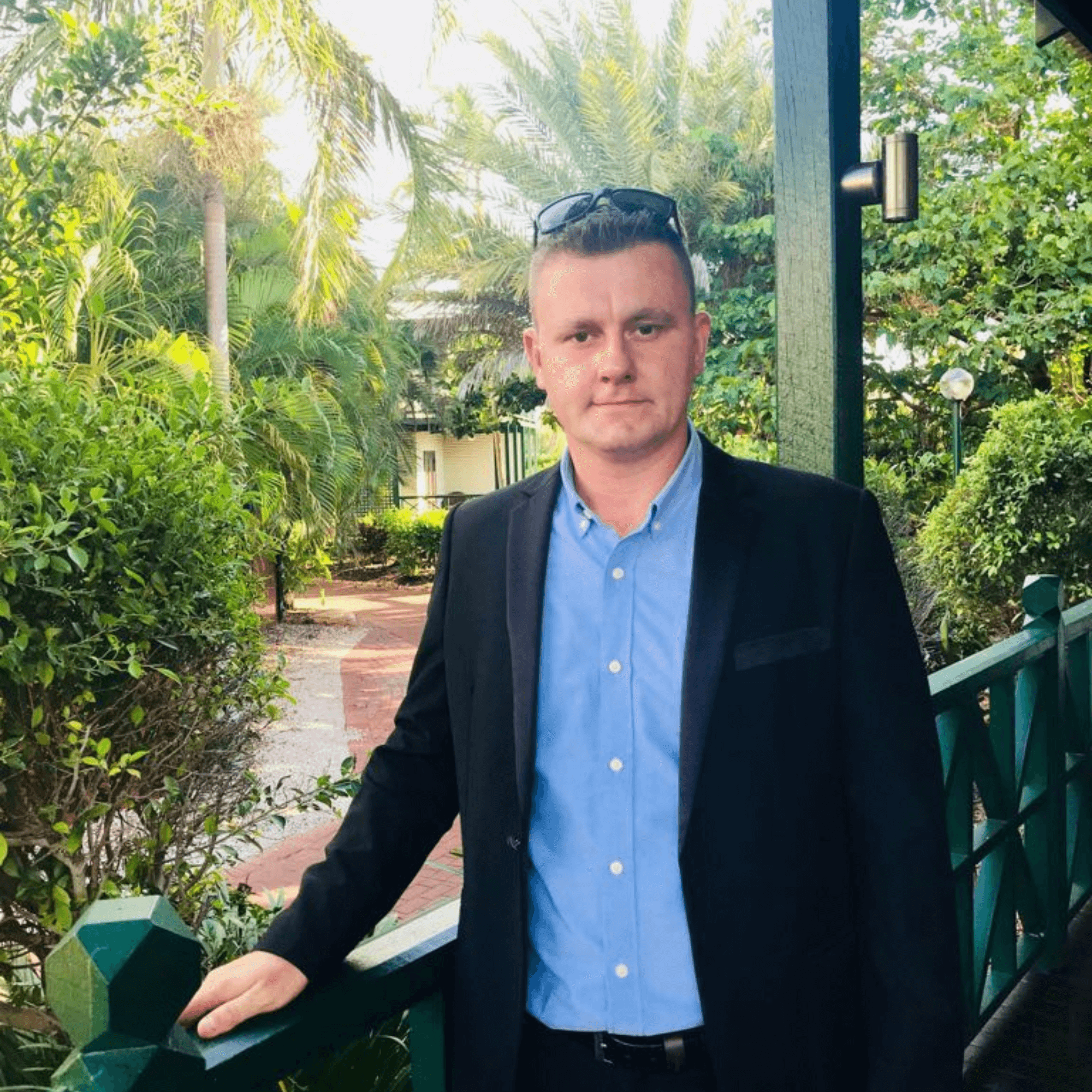 Photo of Adis Smajtic, designer and digital creator at One Stop Centre, standing outdoors by a green railing