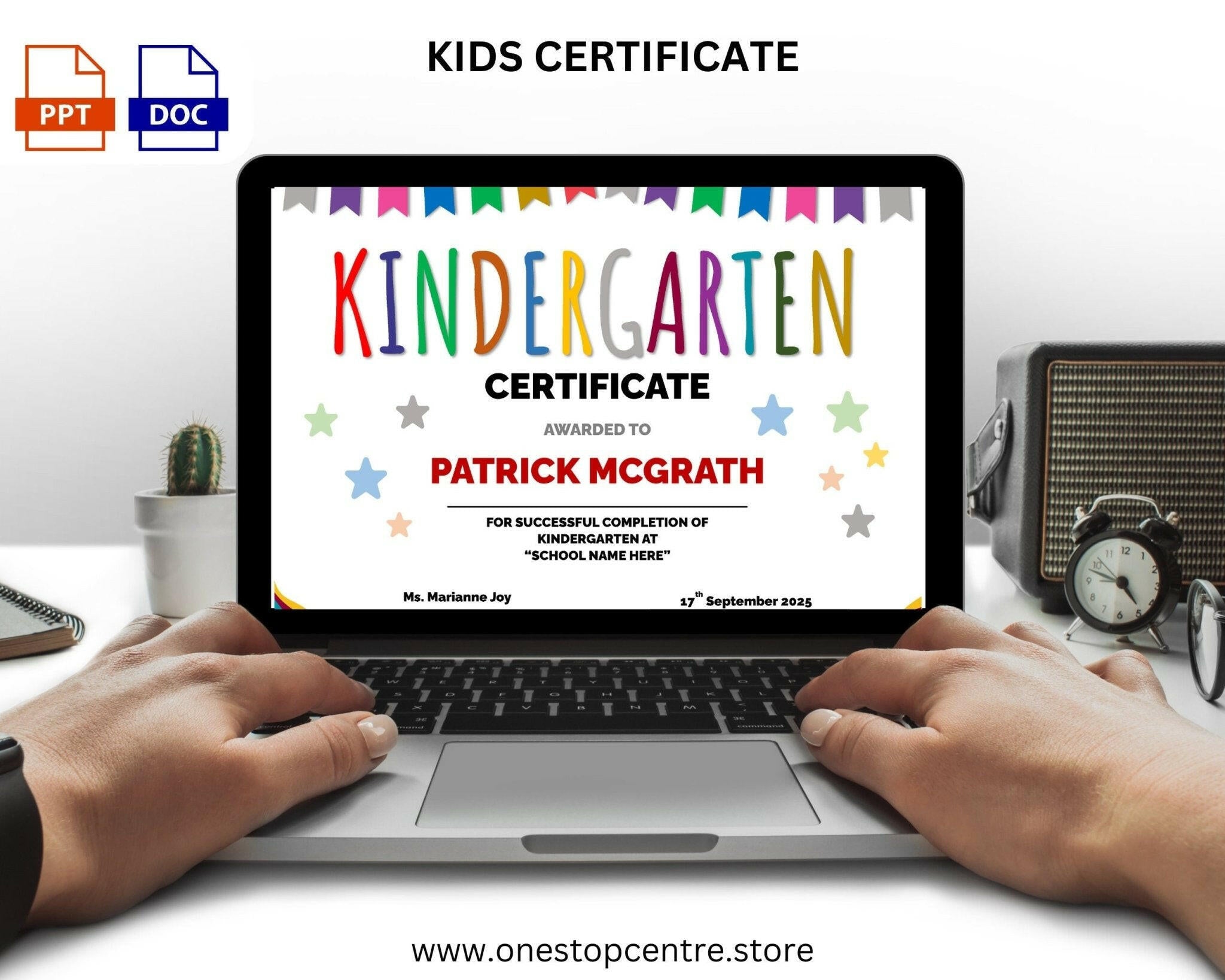 Laptop displaying a kindergarten certificate with colorful text on a white desk.