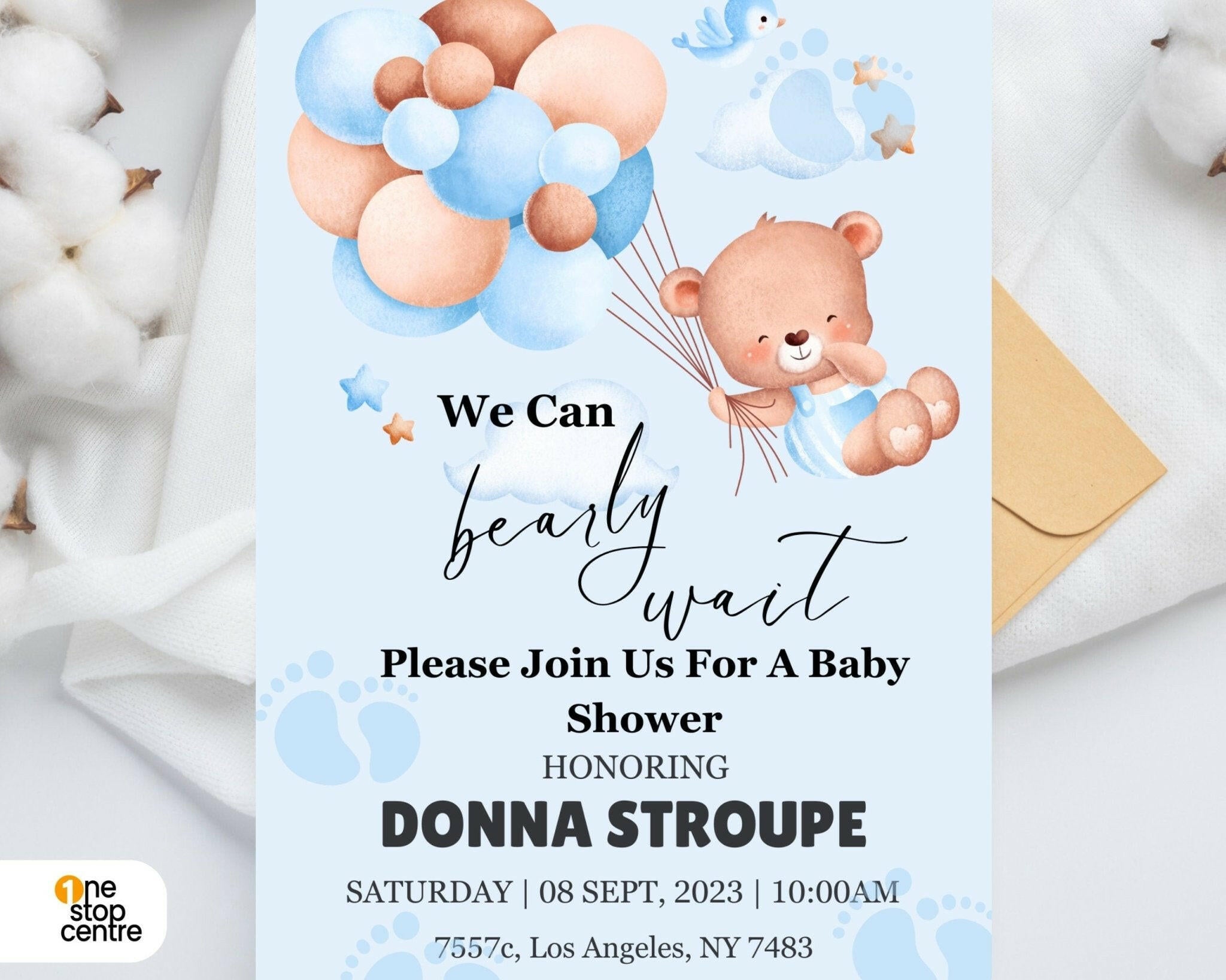 Flat lay of printed teddy bear baby invite on white table