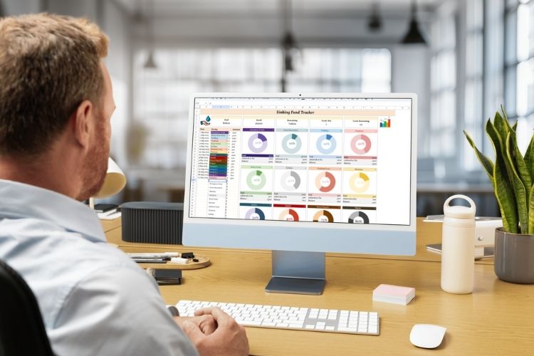 Man analyzing colorful dashboard data on Google Sheets – financial spreadsheet template on desktop monitor in modern office