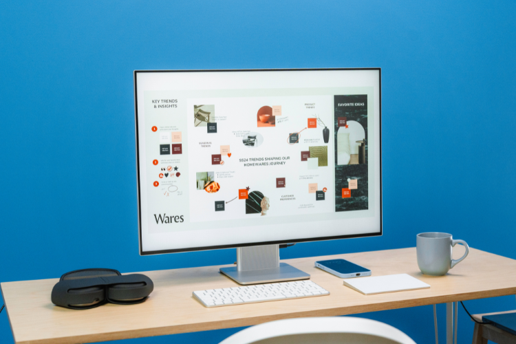 Desktop workspace with monitor displaying digital templates for planners, social media, resumes, OneStopCentre
